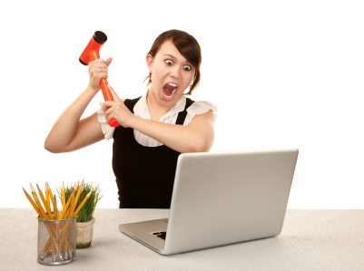 Pretty female office worker destroying laptop computer